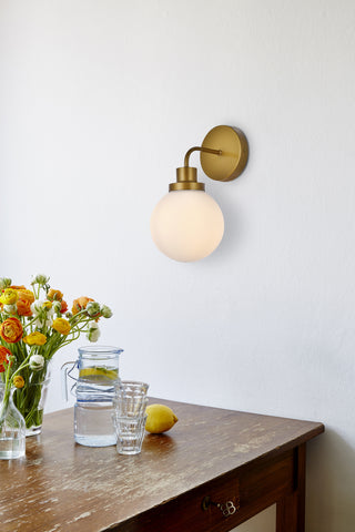 Hanson 1 light bath sconce in brass with frosted shade